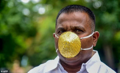 indian man wears gold face mask to ward off coronavirus indian man wears gold face mask to ward off coronavirus