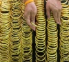 a seller arranges gold bracelets at a jewelry shop in bangkok s chinatown thailand photo reuters file