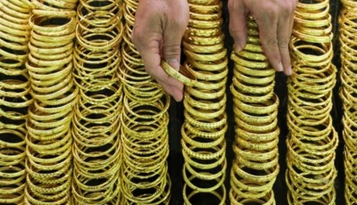 a seller arranges gold bracelets at a jewelry shop in bangkok s chinatown thailand photo reuters file