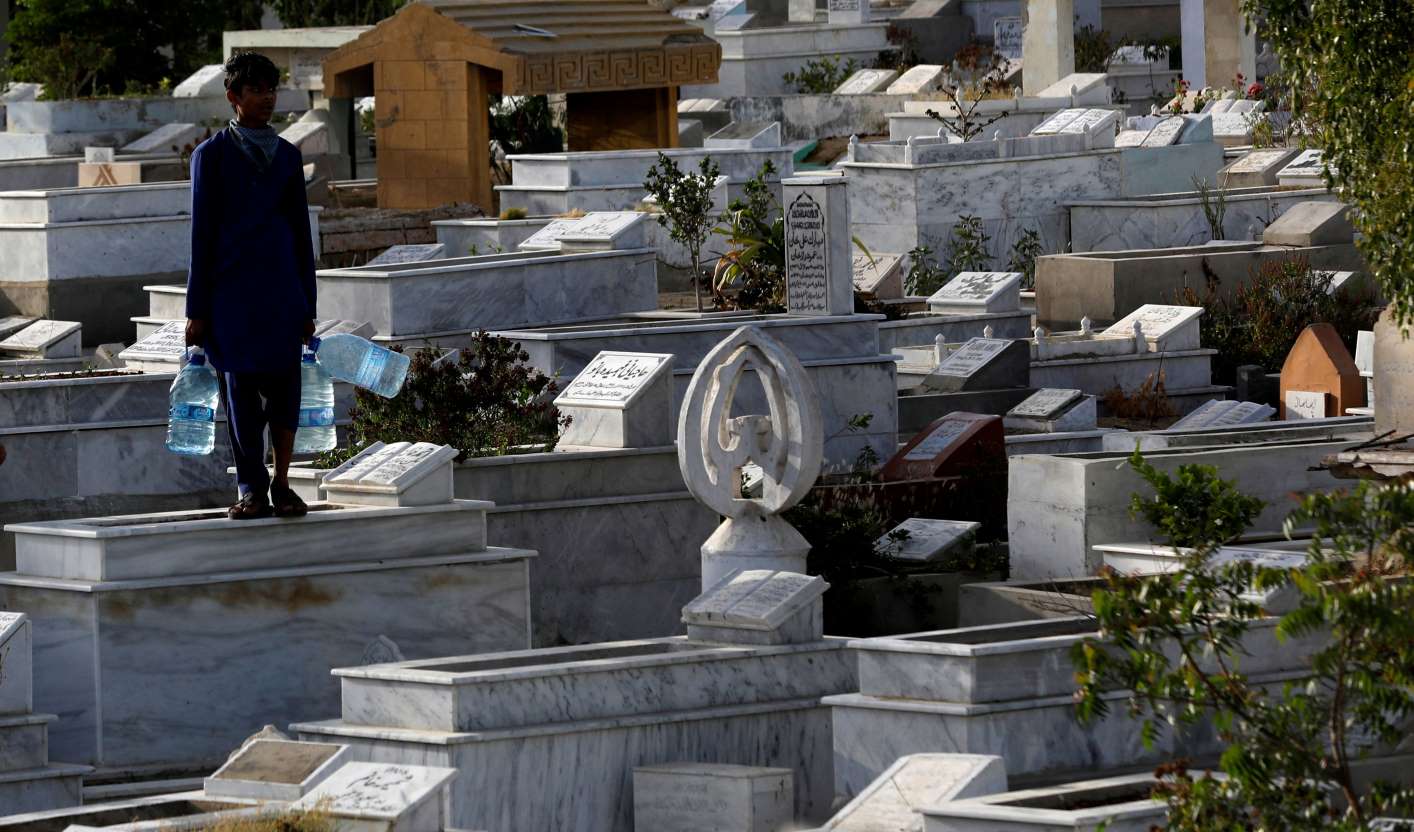 a man roams a graveyard in karachi photo reuters