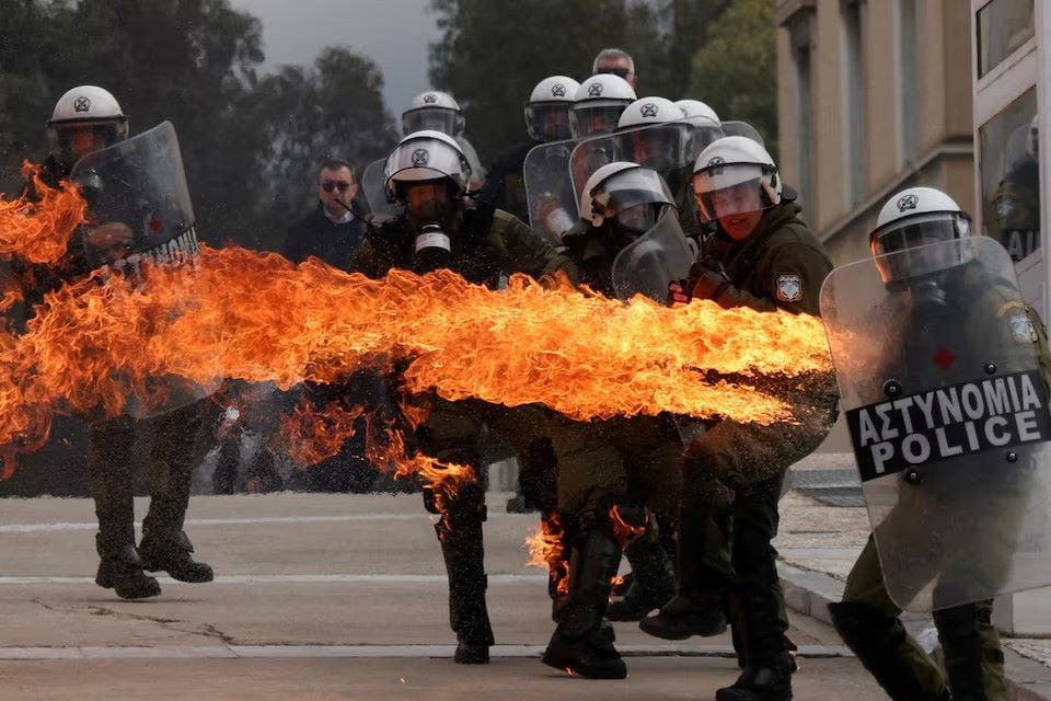 a molotov cocktail ignites striking a riot police officer at a protest near the greek parliament marking the second anniversary of the country s worst railway disaster as an investigation continues in athens greece february 28 photo reuters