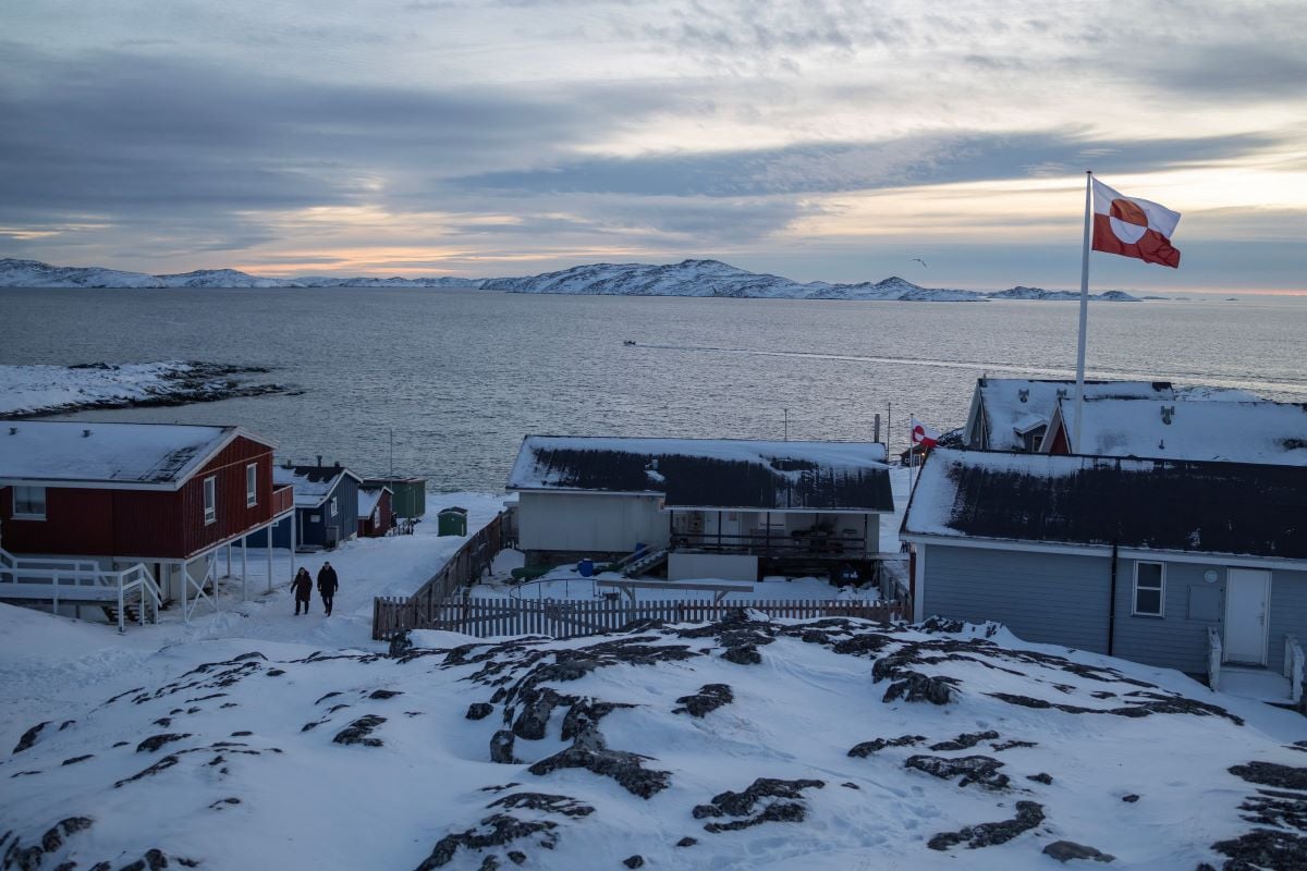 A Greenland flag flies as people walk on the day of a meeting between top US officials and the foreign ministers of Denmark and Greenland, in Nuuk, Greenland, January 14, 2026.PHOTO: REUTERS