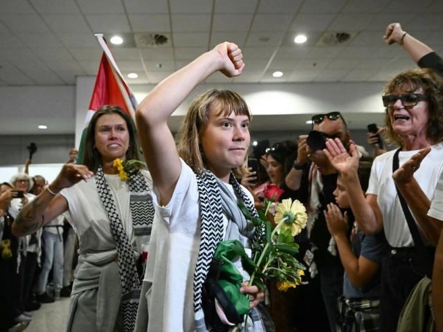swedish climate campaigner greta thunberg raises her fist upon arrival in greece after being deported from israel alongside other activists who were detained aboard vessels from the gaza bound flotilla photo afp
