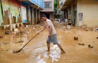 a man clears mud after heavy rainfall brought by typhoon maysak in flooded sanli town in guigang guangxi zhuang autonomous region china july 9 2026 cnsphoto via reuters