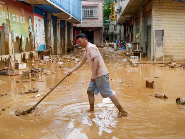 a man clears mud after heavy rainfall brought by typhoon maysak in flooded sanli town in guigang guangxi zhuang autonomous region china july 9 2026 cnsphoto via reuters a man clears mud after heavy rainfall brought by typhoon maysak in flooded sanli town in guigang guangxi zhuang autonomous region china july 9 2026 cnsphoto via reuters