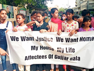 children residing along gujjar orangi drains protest demolition drives