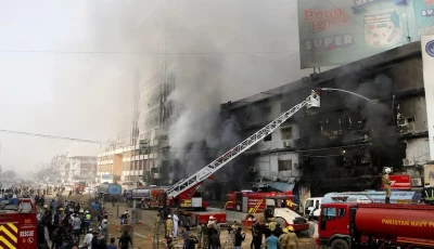 firefighters use a snorkel to douse flames after a blaze erupted at gul plaza market in karachi photo x
