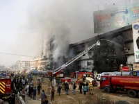 smoke rises as firefighters spray water to extinguish a massive fire that broke out in the gul plaza shopping centre building in karachi pakistan january 18 2026 photo reuters