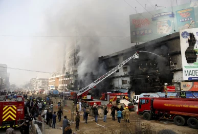 smoke rises as firefighters spray water to extinguish a massive fire that broke out in the gul plaza shopping centre building in karachi pakistan january 18 2026 photo reuters