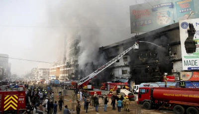 smoke rises as firefighters spray water to extinguish a massive fire that broke out in the gul plaza shopping centre building in karachi pakistan january 18 2026 photo reuters