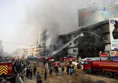 smoke rises as firefighters spray water to extinguish a massive fire that broke out in the gul plaza shopping centre building in karachi pakistan january 18 2026 photo reuters