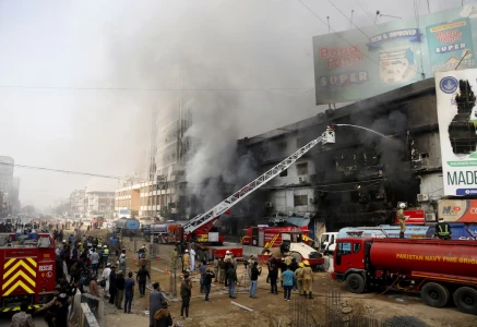 smoke rises as firefighters spray water to extinguish a massive fire that broke out in the gul plaza shopping centre building in karachi pakistan january 18 2026 photo reuters