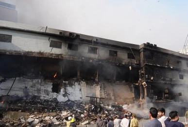 a view of the damaged gul plaza market building after a fire in karachi photo x