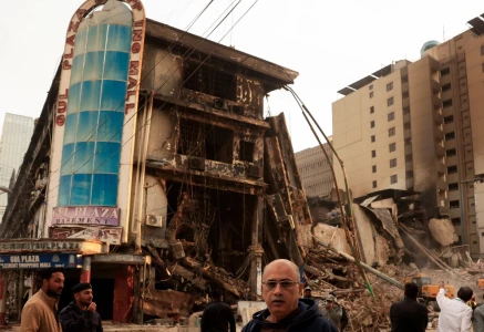muhammad imran 56 a crockery shop owner who survived looks on following a massive fire that broke out in the gul plaza shopping mall in karachi on january 23 photo reuters