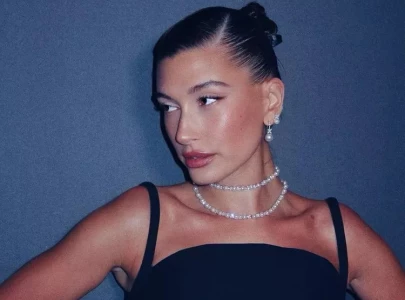 hailey bieber embraces red for another summer and introduces butter yellow in her maternity style
