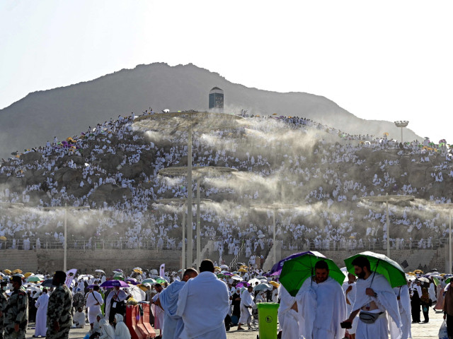 pilgrims crowd jabal al rahma on the plains of arafat photo afp