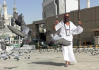 a muslim pilgrim walks among pigeons near the grand mosque in mecca saudi arabia may 19 reuters