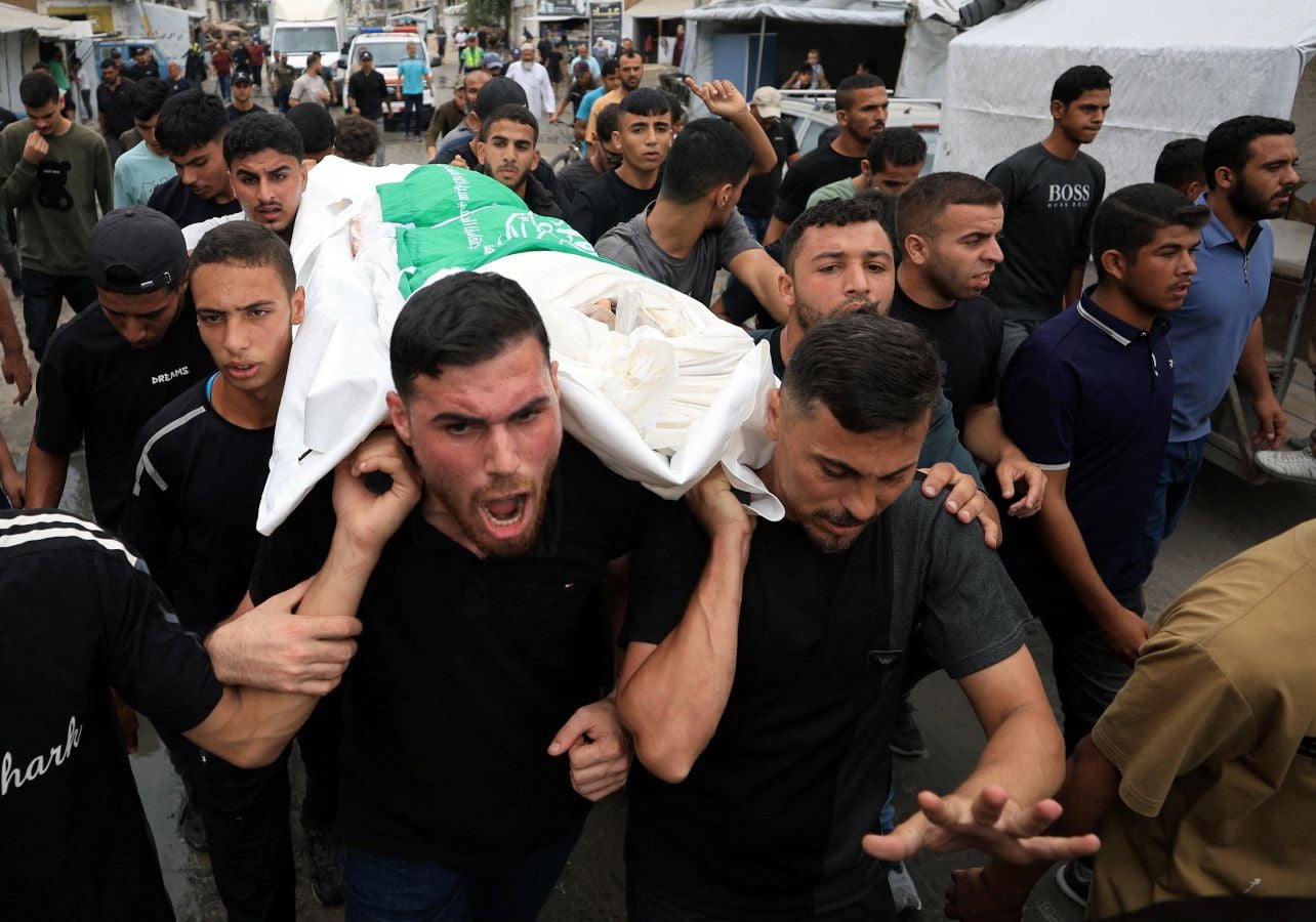 Palestinians react as they carry the bodies during the funeral of Al-Qassam Brigades Commander Izz al-Din al-Baik and his bodyguard, who were killed in an Israeli airstrike that targeted an apartment, according to medics, in Gaza City, September 29, 2026. REUTERS