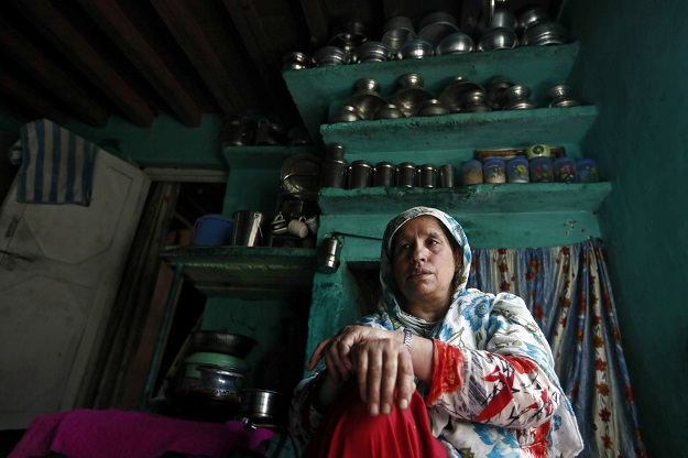 Haseena Malik shows a photograph of her son Uzair Maqbool Malik (Photo: Reuters)