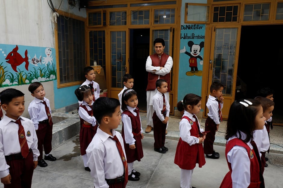 Mohammad Asif Shahyan from the Hazara community, CEO of a Pioneers school, watches an assembly prayer in Mariabad, Quetta. PHOTO: Rueters