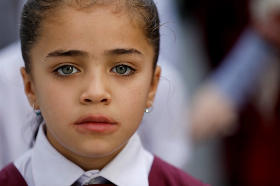 A Hazara girl attends an assembly prayer in Mariabad, Quetta, PHOTO: Reuters