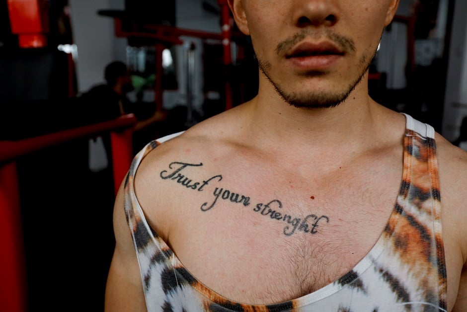 Naveed Ali Hazara, 23, poses for a photograph at a gym in Hazara Town PHOTO: Reuters