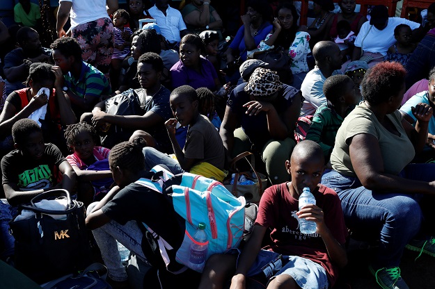 People sit in a ferry at Marsh Harbour Government Port during an evacuation operation after Hurricane Dorian hit the Abaco Islands. PHOTO: Reuters