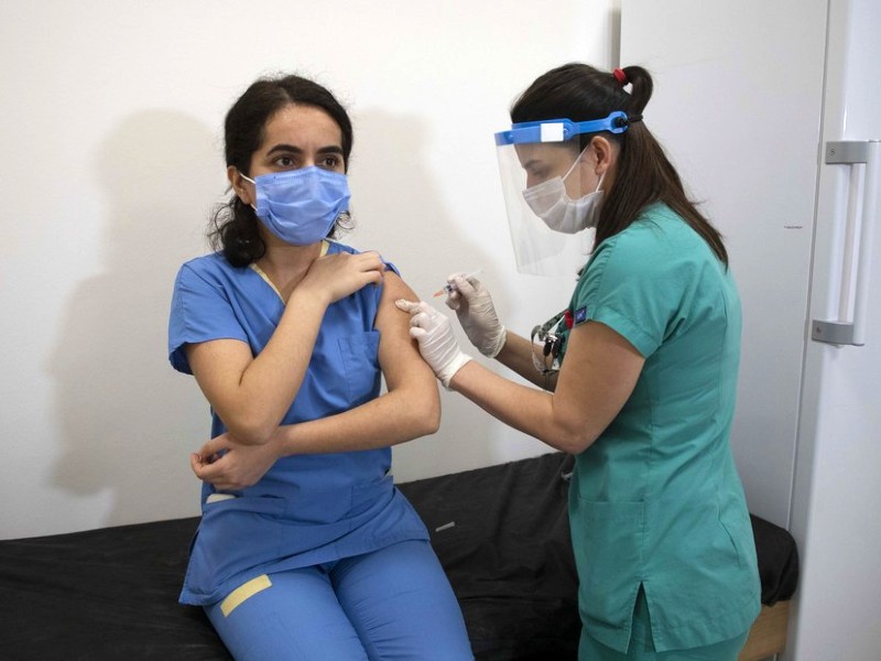 a health worker receives a dose of covid 19 vaccine from china in istanbul turkey on feb 11 2021 photo xinhua