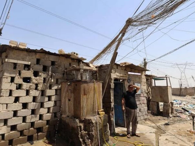 an iraqi electrician takes a break from working on a power generator in the southern city of diwaniyah on august 10 2025 amidst rising temperatures chronic water shortages and power cuts photo afp