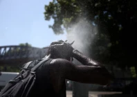 a person cools off at a water mister on a street in paris as temperatures rise during a heatwave affecting a large part of france june 22 2026 reuters