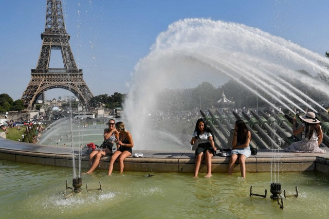 people cool off at the trocadero fountains next to the eiffel tower in paris as a new heatwave hits europe photo afp file