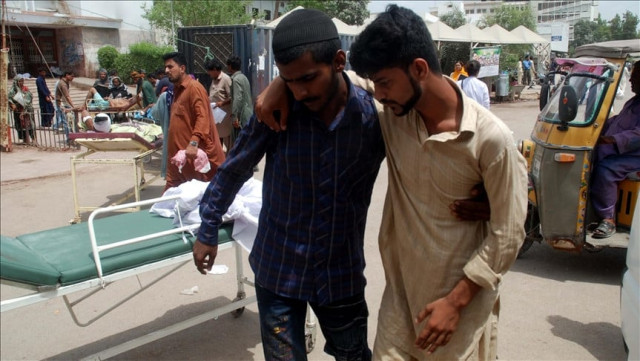 people shift a patient who was affected by heatwave to a hospital in karachi photo file people shift a patient who was affected by heatwave to a hospital in karachi photo file