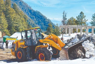 heavy machinery is being used to clear a road of snow in abbottabad photo ppi