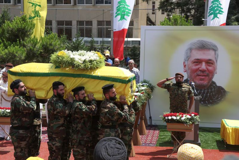 members of hezbollah carry the coffin of taleb abdallah also known as abu taleb a senior field commander of hezbollah who was killed by what security forces say was an israel strike yesterday night during his funeral in beirut s southern suburbs lebanon june 12 2024 photo reuters