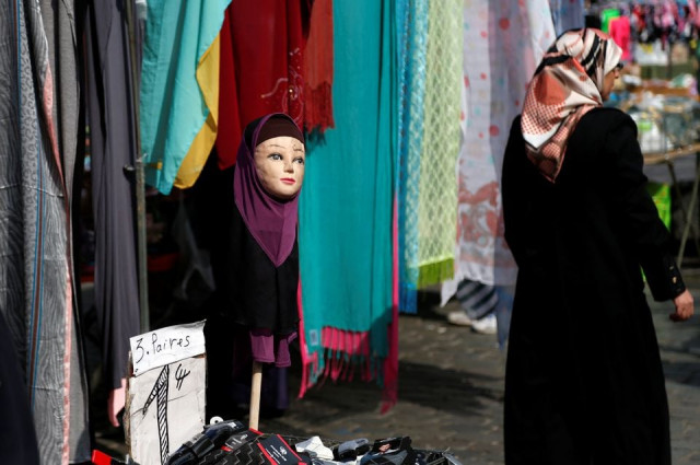 a woman walks past a mannequin wearing an hijab headscarf at a market in the brussels district of molenbeek belgium august 14 2016 photo reuters file a woman walks past a mannequin wearing an hijab headscarf at a market in the brussels district of molenbeek belgium august 14 2016 photo reuters file