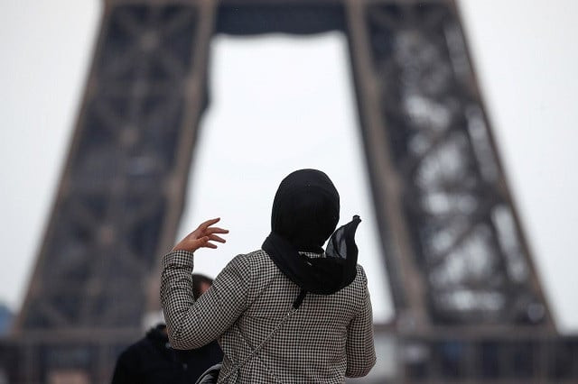 a woman wearing a hijab walks at trocadero square near the eiffel tower in paris france may 2 2021 photo reuters a woman wearing a hijab walks at trocadero square near the eiffel tower in paris france may 2 2021 photo reuters