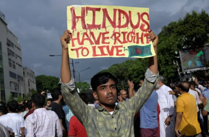 a demonstrator displays a placard during a protest against what they say violence against hindu communities during ongoing unrest in dhaka bangladesh august 9 2024 photo reuters a demonstrator displays a placard during a protest against what they say violence against hindu communities during ongoing unrest in dhaka bangladesh august 9 2024 photo reuters