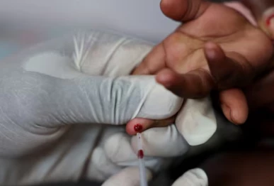 a nurse draws a blood sample from a child for an hiv test at a clinic in south africa photo reuters file