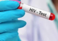 a lab assistant holds test tube filled with hiv positive blood sample photo app file