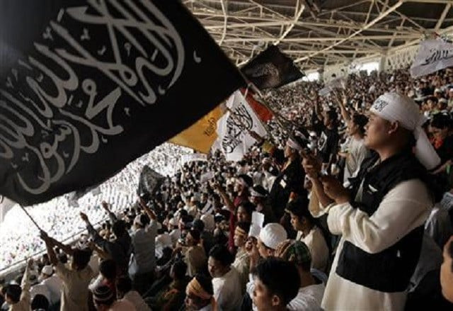 a member of hizbut tahrir indonesia waves a flag at the international caliphate conference at bung karno stadium in jakarta august 12 2007 photo reuters a member of hizbut tahrir indonesia waves a flag at the international caliphate conference at bung karno stadium in jakarta august 12 2007 photo reuters
