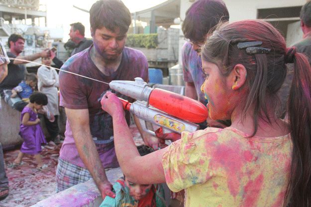 a child plays with a water gun during holi at shri lakshmi narayan mandir photo ayesha mir