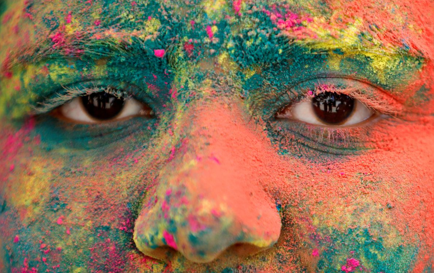 the face of a girl is seen daubed in colours as she takes part in holi celebrations in ahmedabad india march 18 2022 reuters amit dave