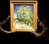 staff members pose with vincent van gogh s chataigniers en fleurs chestnut trees in blossom at a media preview ahead of its auction in new york at sotheby s in hong kong china photo reuters