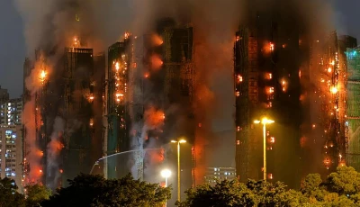 thick smoke and flames rise as a major fire engulfs several apartment blocks at the wang fuk court residential estate in hong kong s tai po district on november 26 2025 photo afp