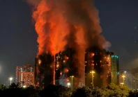 thick smoke and flames rise as a major fire engulfs several apartment blocks at the wang fuk court residential estate in hong kong s tai po district on november 26 2025 at least four people were killed when a fire engulfed several high rise blocks in a hong kong residential estate on november 26 the government said with media reporting that some residents were trapped inside photo afp