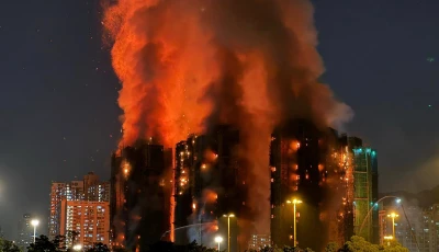 thick smoke and flames rise as a major fire engulfs several apartment blocks at the wang fuk court residential estate in hong kong s tai po district on november 26 2025 at least four people were killed when a fire engulfed several high rise blocks in a hong kong residential estate on november 26 the government said with media reporting that some residents were trapped inside photo afp