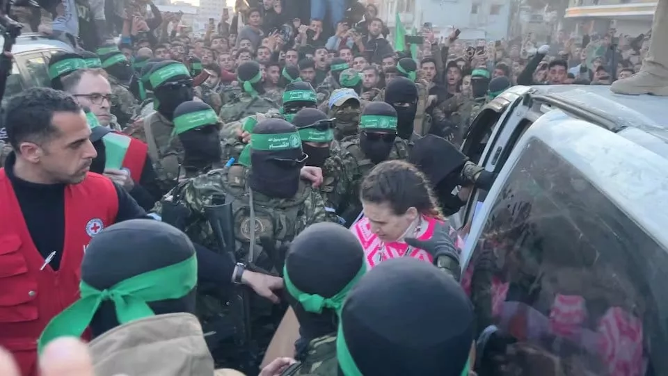palestinian hamas militants hand over hostages gaza city january 19 2025 photo reuters palestinian hamas militants hand over hostages gaza city january 19 2025 photo reuters