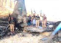 houthi fighters stand in front of what they say is a downed saudi jet at a location given as yemen photo houthi military media handout via reuters