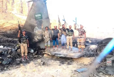 houthi fighters stand in front of what they say is a downed saudi jet at a location given as yemen in this still image from a handout video released on september 16 2026 houthi military media handout via reuters