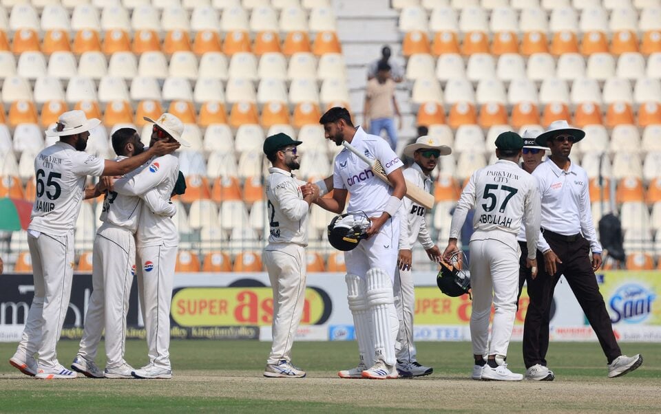 Pakistan players shake hands with England players and celebrate after the match REUTERS/Akhtar Soomro